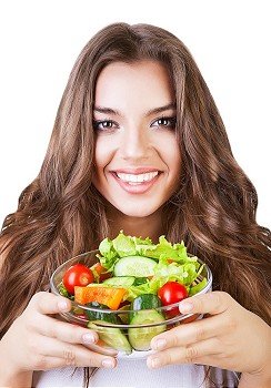 beautiful healthy friendly woman with salad on white background