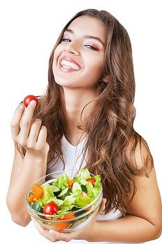 happy girl with tomato in hand on white background