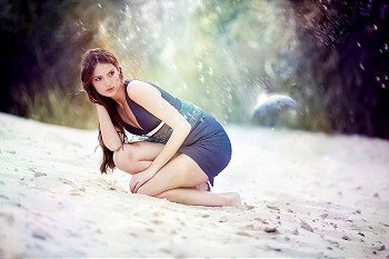 Woman in blue dress on the cosmic beach sand