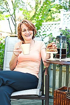 Woman in backyard with coffee and cookies