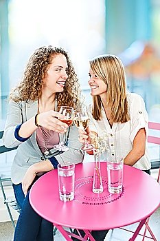 Women toasting with white wine