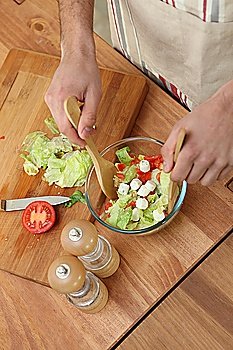 Man making salad in kitchen