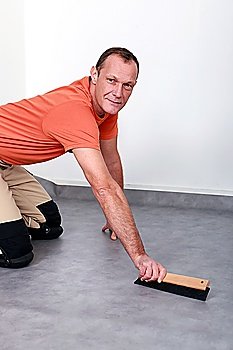 Man smoothing carpet
