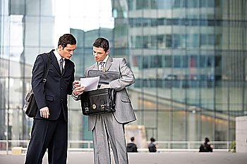 Two businessmen checking a document