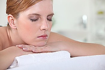 Woman with her eyes closed during a back massage