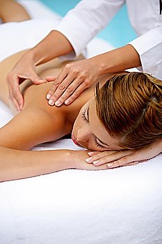 Woman receiving a poolside back massage