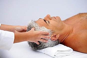 mature man having a scalp massage