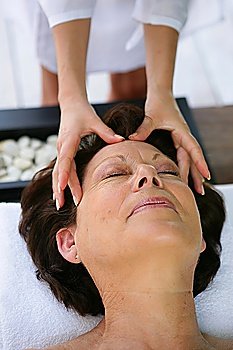 Woman being treated to head massage