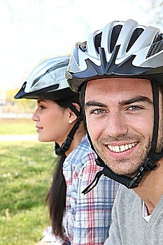 Couple of cyclists wearing helmets