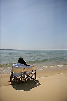 Couple sitting by the sea