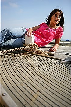 Woman lying on board the deck of a boat