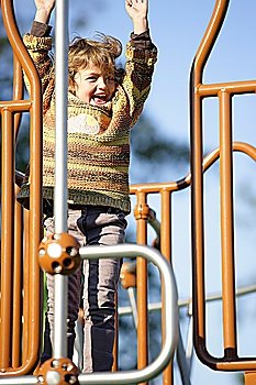 Little girl playing on a climbing frame