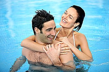 Couple hugging in swimming pool