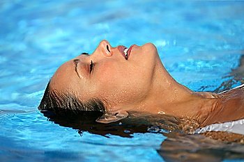 Woman laying in swimming pool
