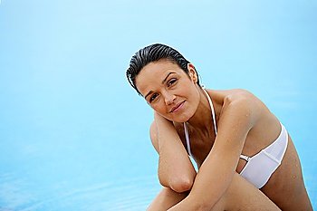 Woman relaxing at a poolside