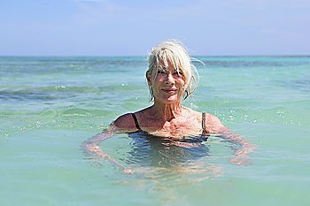 Senior woman swimming in the sea