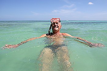 a man swimming with a snorkel and a diving mask