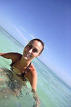 Attractive brunette swimming in the sea