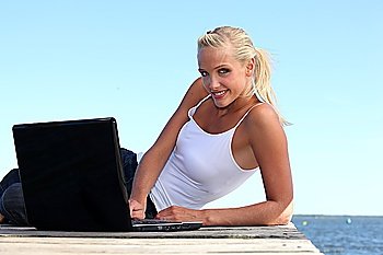 Woman with computer in a dock