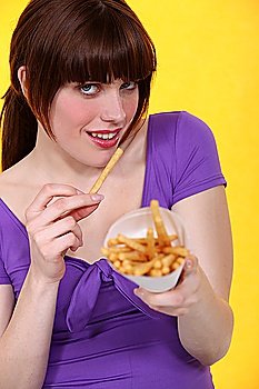woman eating French fries