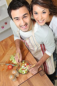 Top-view of couple making salad
