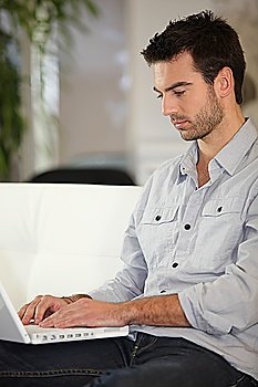 Man sitting on couch with computer