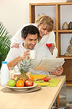 Couple at breakfast with a newspaper
