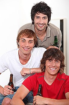 Three lads with bottles of beer