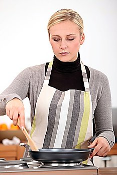 Woman with pan in the kitchen