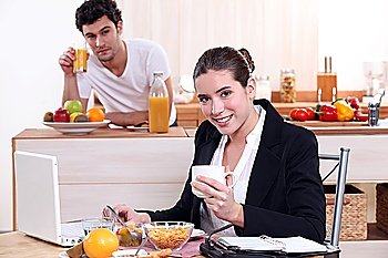 Young couple having breakfast together in kitchen