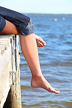 Bare feet on the end of a pier