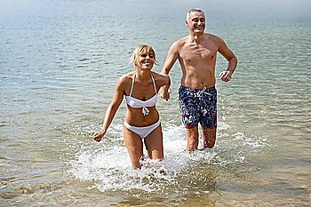 Couple running in the sea