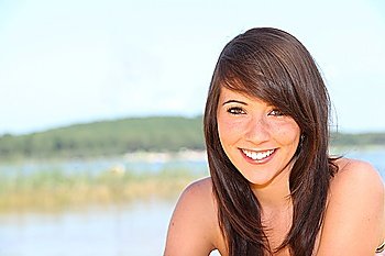 Young brunette by lake
