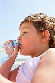 Child drinking from a bottle of water