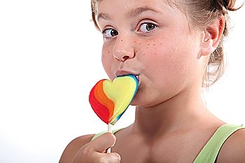 Little girl holding lollipop