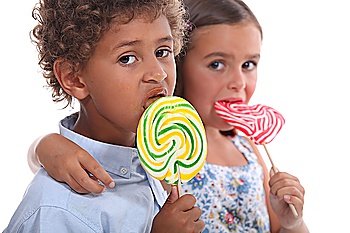 couple of children with lollypops