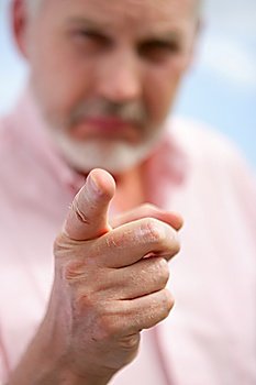 Older man pointing his finger at the camera