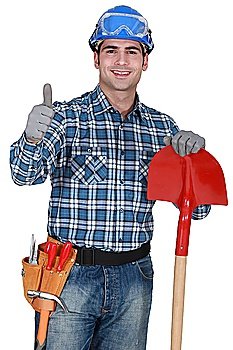 Manual worker with gloves and spade giving thumbs-up