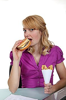 Woman eating burger and fries