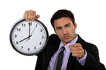 young businessman holding a clock