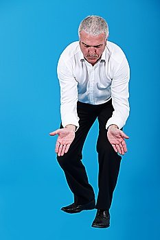 businessman kneeling and holding his hands wide open