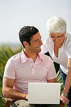 Man and senior woman with a laptop