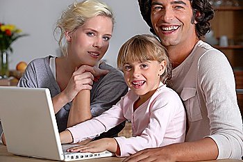 parents initiating little girl to computer