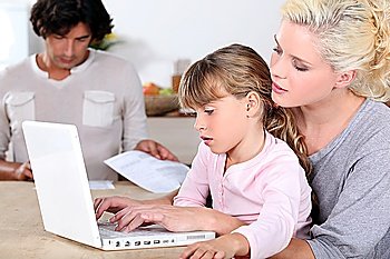 Mother with girl and computer