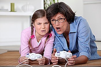 Little girl playing a computer game with her grandma