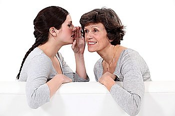 Woman telling her mother a secret