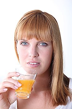 Young woman drinking orange juice isolated on white background