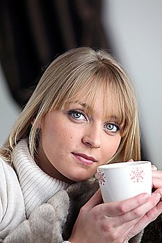 Blond woman relaxing with coffee
