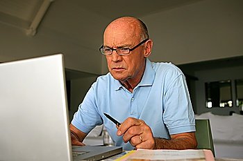 Elderly man concentrating on his work