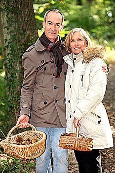 Middle-aged couple with basket of mushrooms